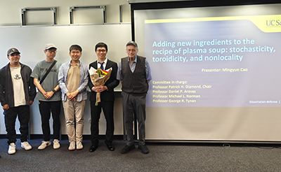 Mingyun Cao surrounded by colleages at his thesis defense